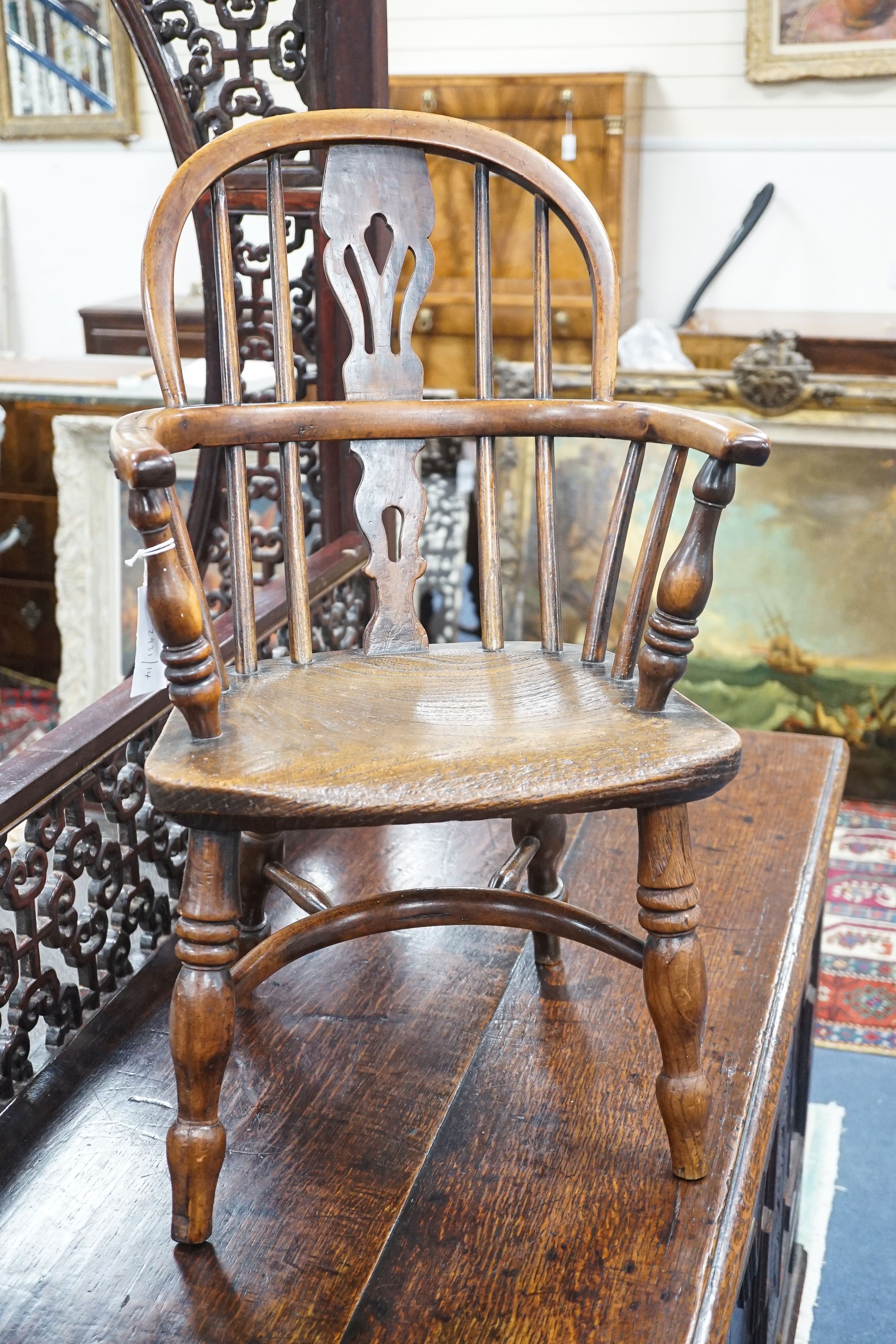 A 19th century Midlands area yew and elm Windsor child's elbow chair with crinoline stretcher, width 37cm, depth 44cm, height 65cm